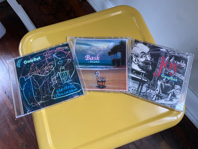 Three Cowbot CDs laying on a stool